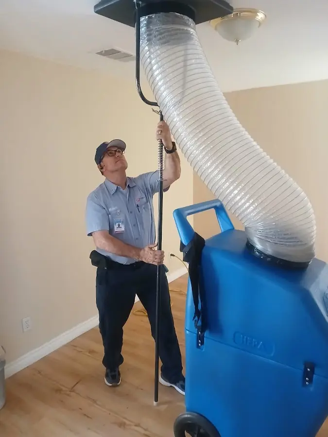 Furnace Tune-Up technician using HEPA equipment in Florence